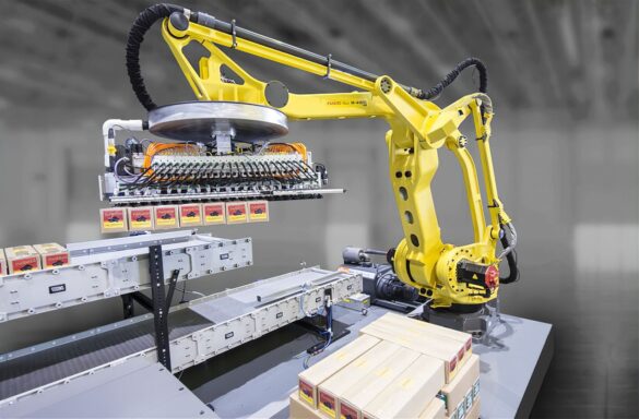 FANUC M-410iC robot palletizing boxes in a modern warehouse facility.